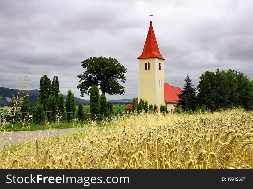 Church in the forefront of grain, Velke Uherce Slovakia