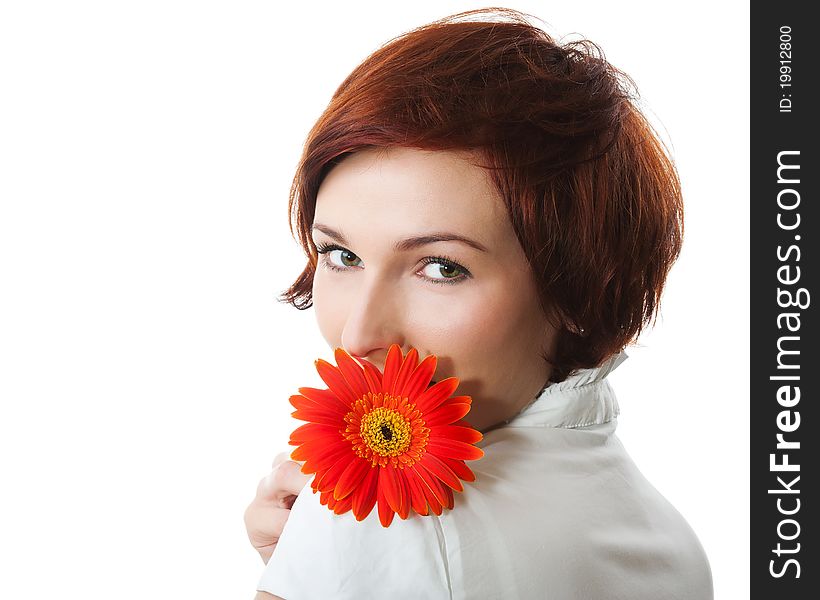 Beautiful woman with flower gerbera in her hands against white background