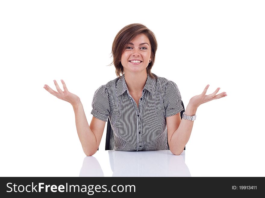 Young beautiful business woman behind the desk with open arms, isolated