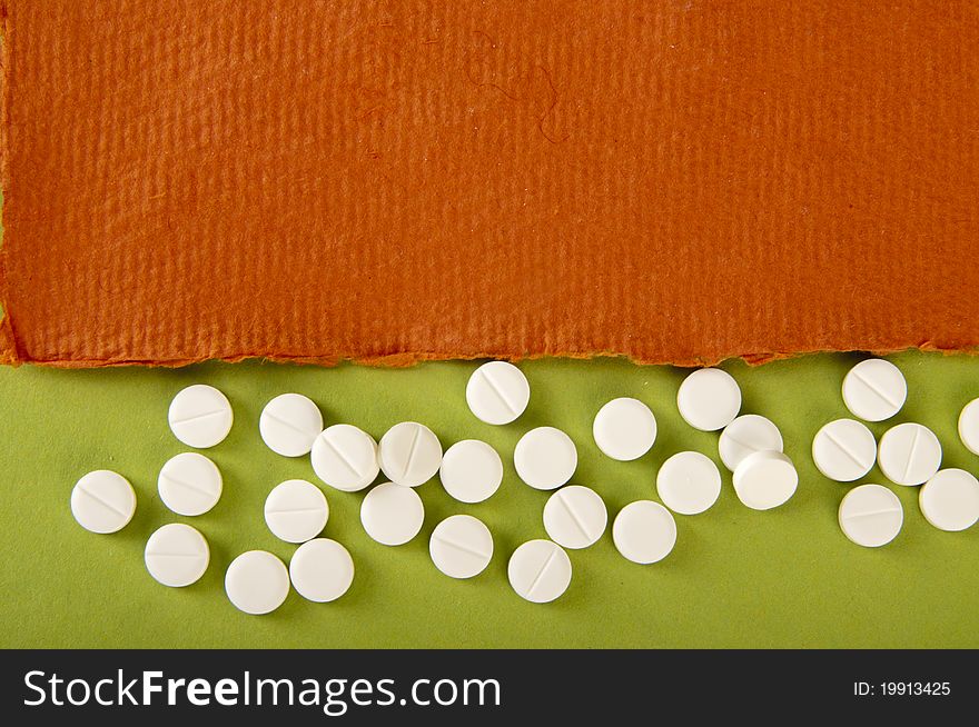 Pills background with orange and green paper