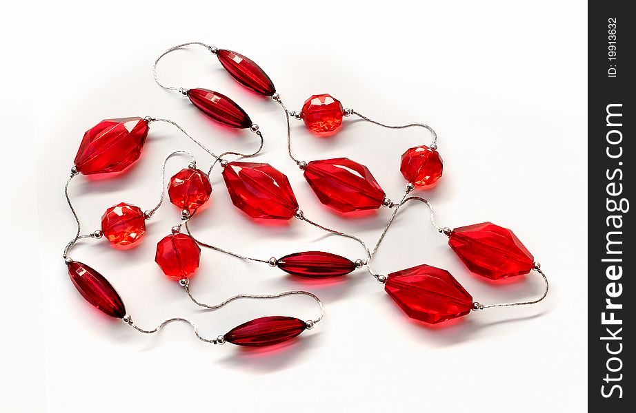 Rubine red glass diamonds necklace silver chain white background. Rubine red glass diamonds necklace silver chain white background