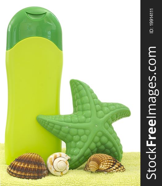 In green with shells on the towel. In green with shells on the towel