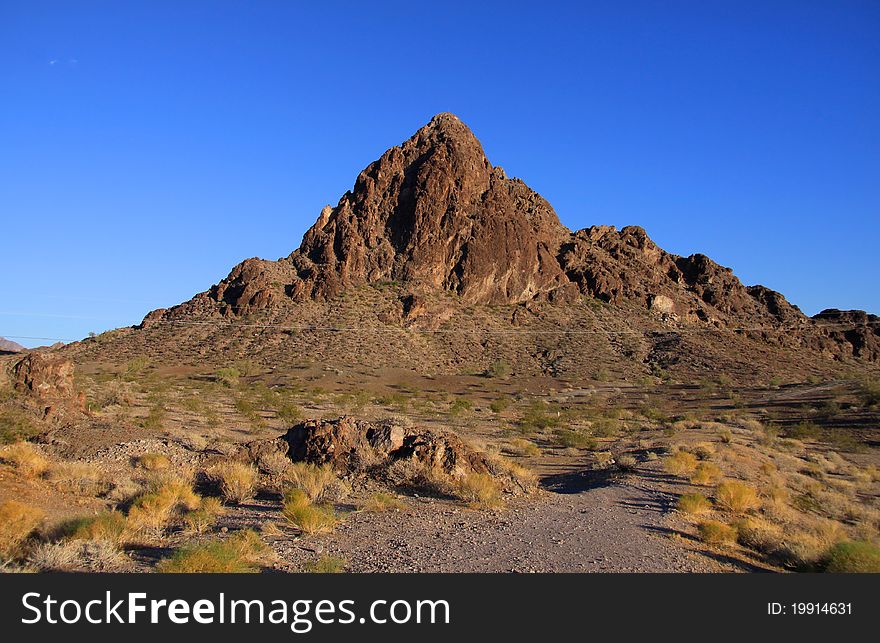Sandstone butte in western Arizona against blue sky background