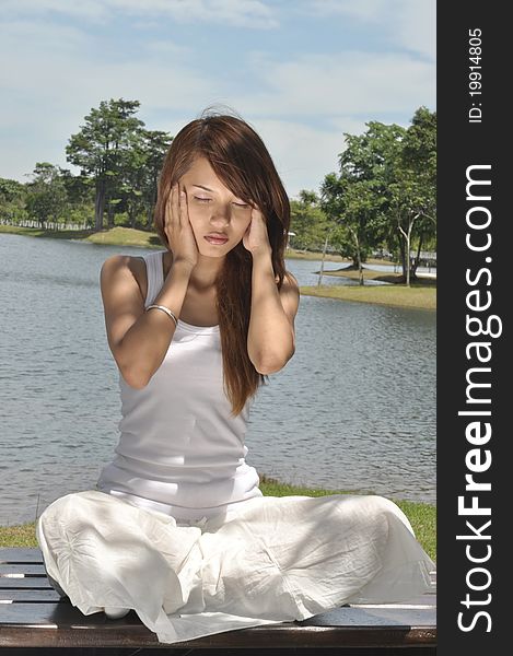 Young girl practicing yoga in the park