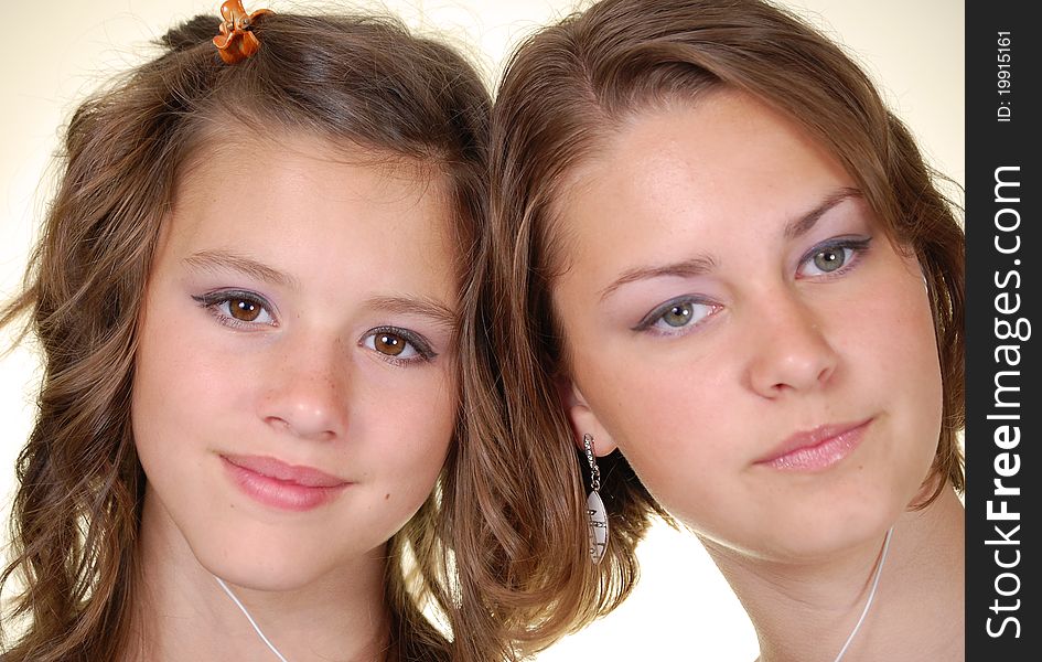 Two beautiful young women listening to their MP3 players. Two beautiful young women listening to their MP3 players