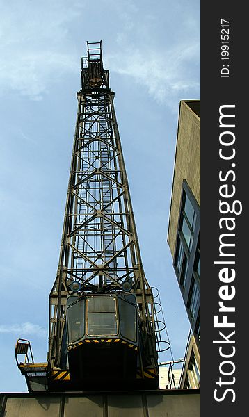 Old crane at harbour with cloudy sky, Dusseldorf, Germany.