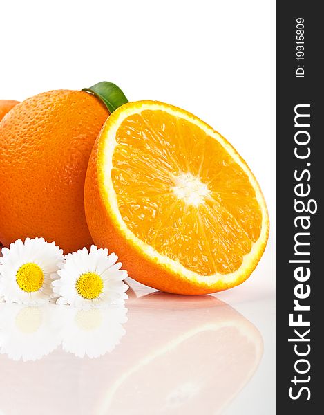 Fresh orange and camomile isolated on a white background