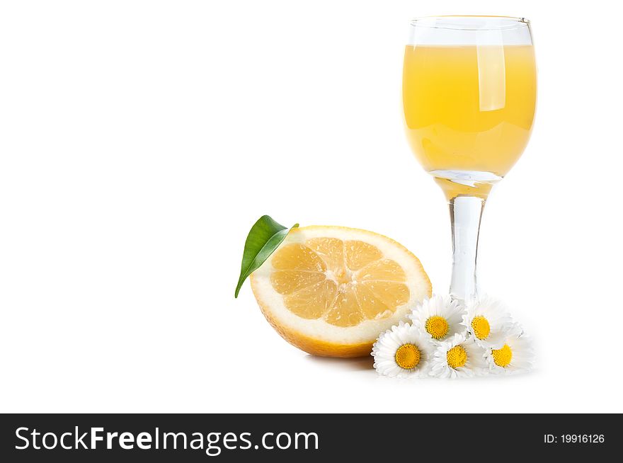 Lemon and juice in a glass isolated on a white background