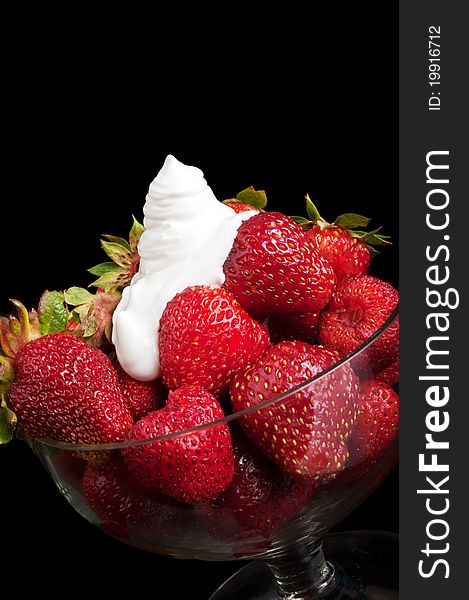 Appetizing strawberry and cream on a black background