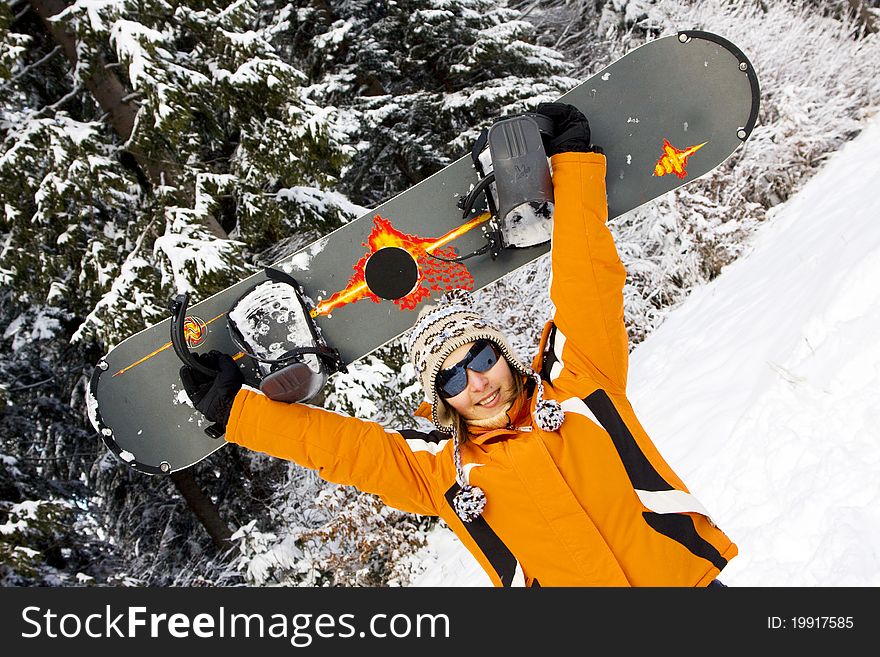 Beautiful young woman snowboarder on slope