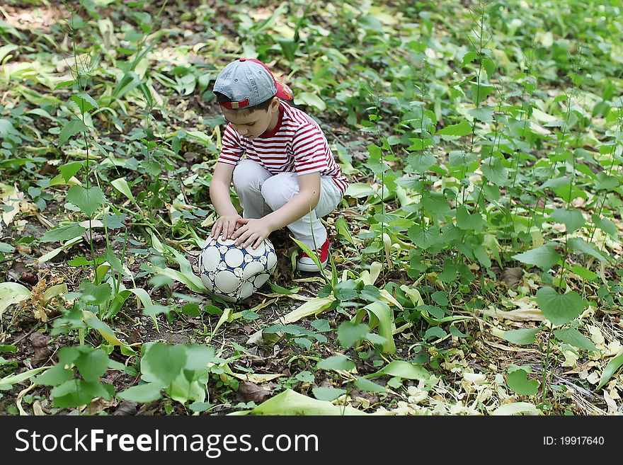 Boy outdoor with football ball. Boy outdoor with football ball.