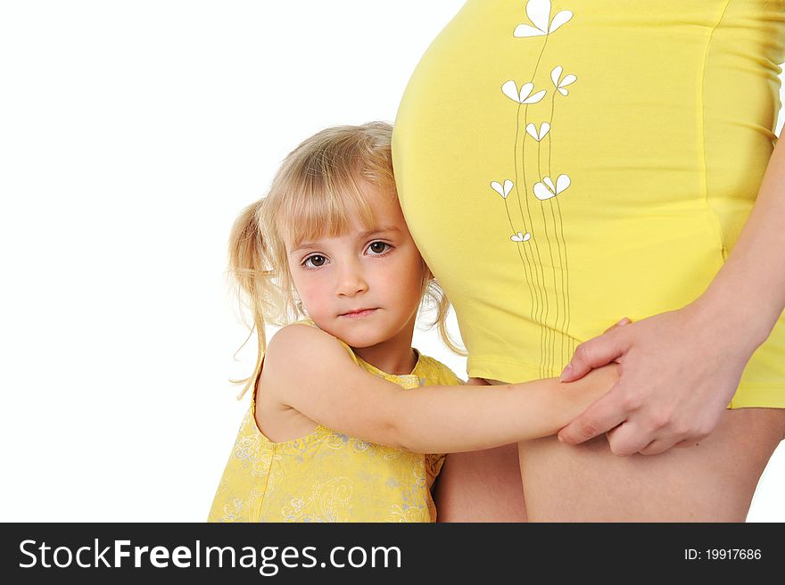Adorable girl hugging belly pregnant mom's. Adorable girl hugging belly pregnant mom's