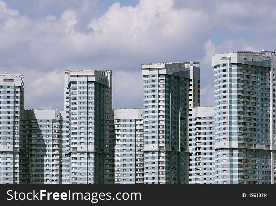 Blue and white multifamily housing n the blue sky