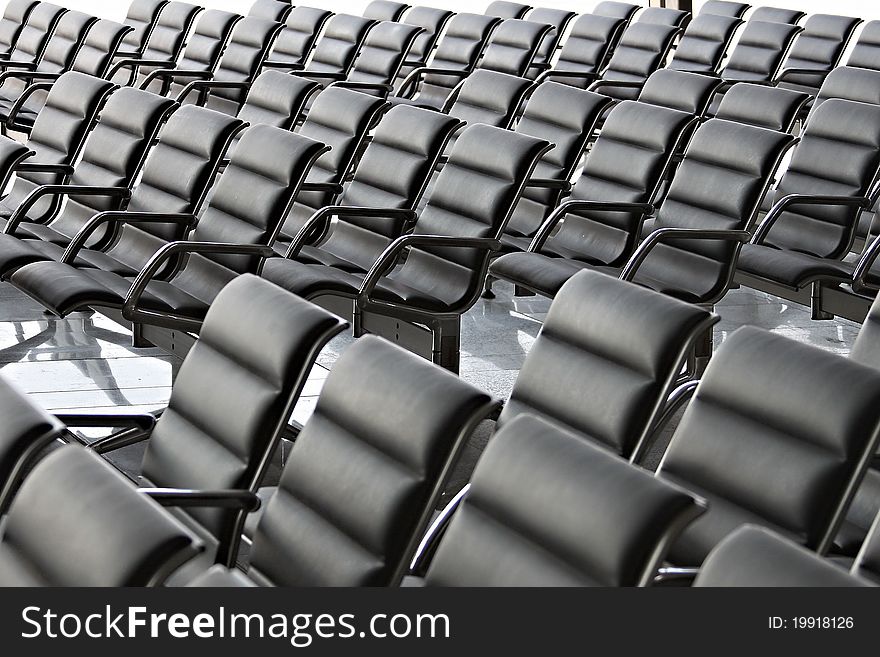 Empty Conference Hall or Waiting Space with black chairs