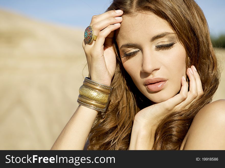 Portrait of a beautiful adult sensuality brunette woman on sand desert background. Portrait of a beautiful adult sensuality brunette woman on sand desert background