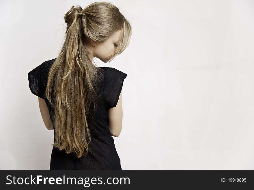 Image of a beautiful young blonde haired female looking downwards to her right - with a light coloured background. Image of a beautiful young blonde haired female looking downwards to her right - with a light coloured background