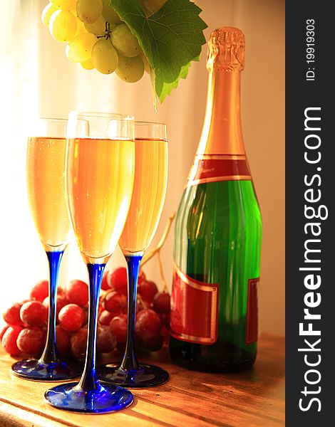 Champagne in glasses,grapes and grape-vine leaves