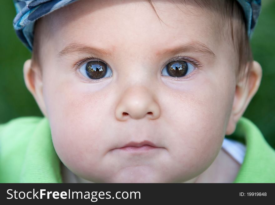 Cute serious baby portrait outdoors. Cute serious baby portrait outdoors