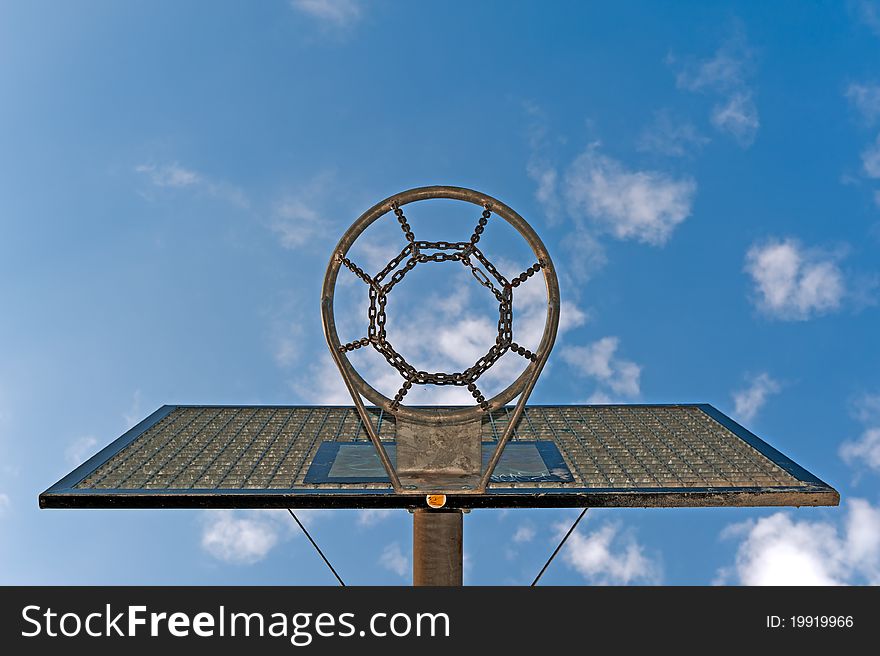 A basketball hoop against a cloudy sky