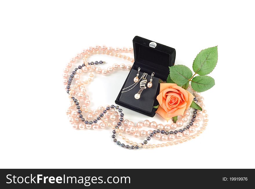 Precious pearls set in open gift box with yellow rose and pearl necklace