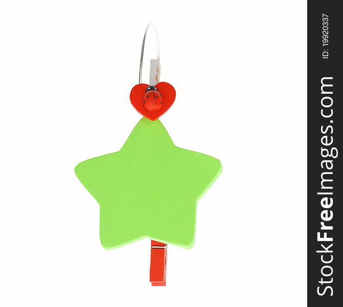 Colored green star paper and red clip on white background