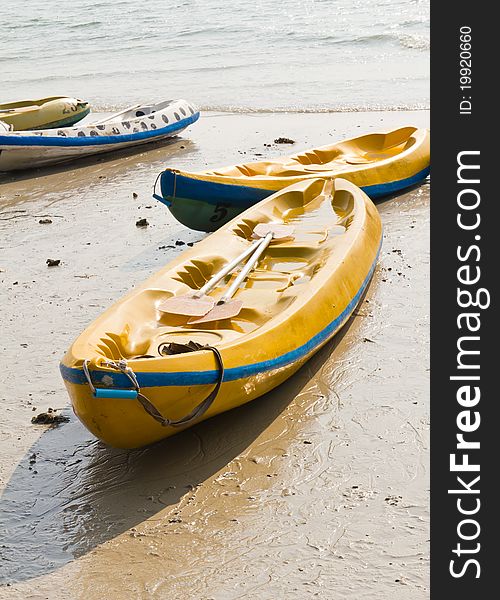 Old Colourful kayaks on the beach