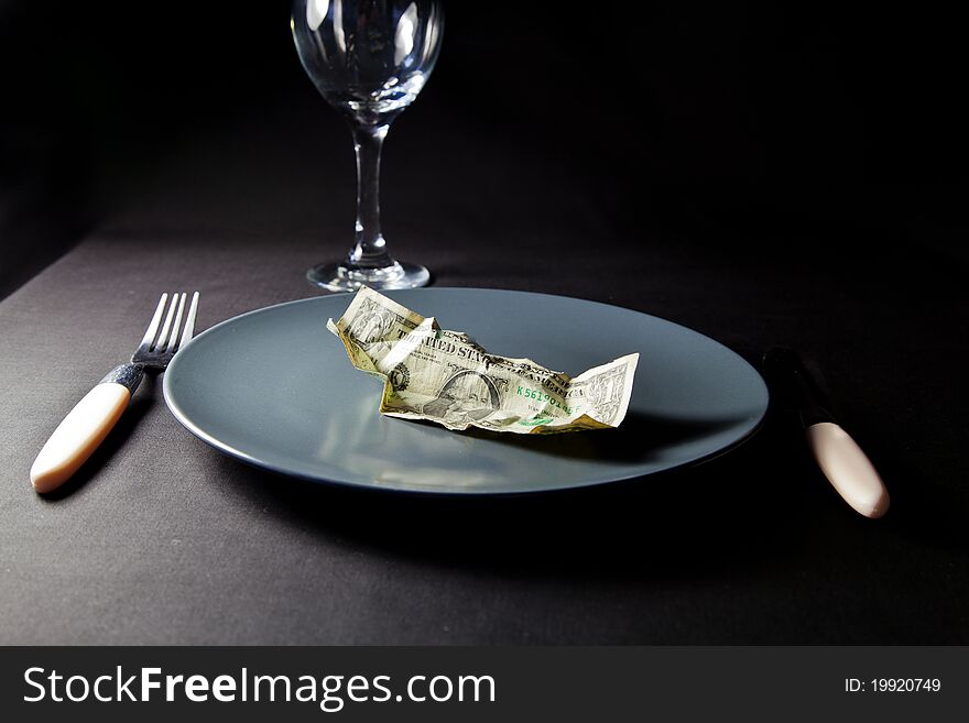 One dollar bill on a plate