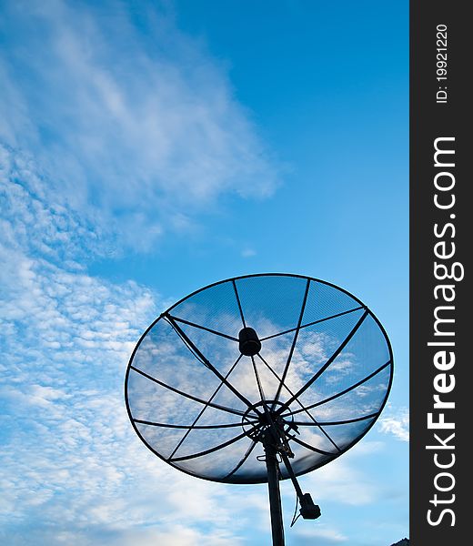 Satellite dish with blue sky on the background (vertical)