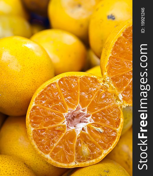 Many oranges and half orange from Thailand (Vertical)