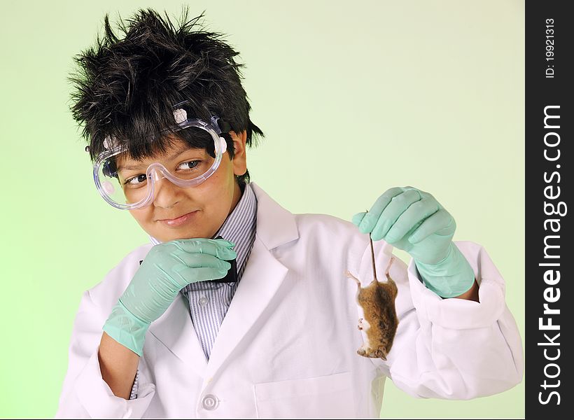 A young mad scientist skittishly examining the dead mouse he's holding by the tail. A young mad scientist skittishly examining the dead mouse he's holding by the tail.