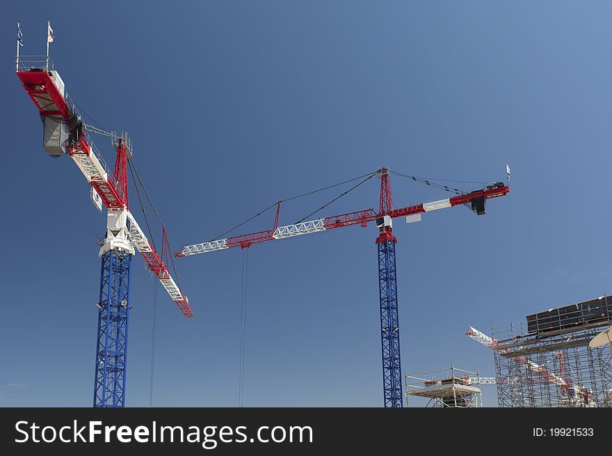 Red and white cranes on a construction site