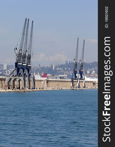 Five cranes on the dock of a harbor. Five cranes on the dock of a harbor