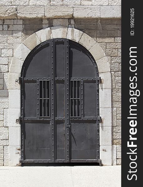 Large Metallic Door And Stone Wall