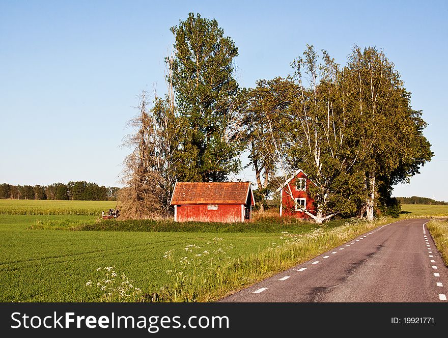 Red rural cottage att the road in Sweden. Red rural cottage att the road in Sweden.