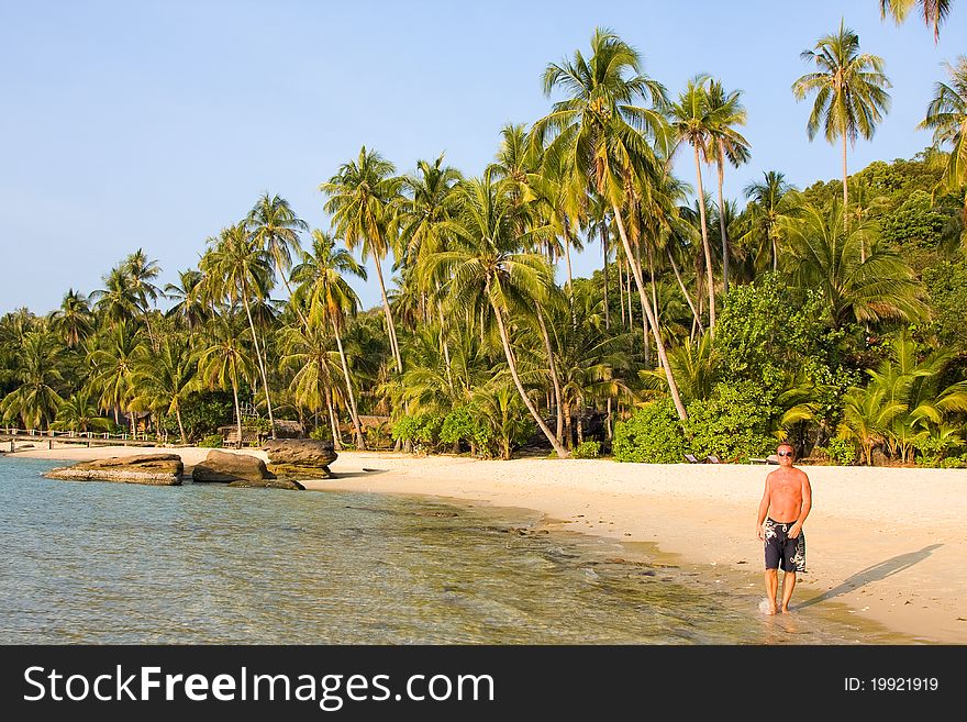 Man goes on an exotic beach . Thailand .