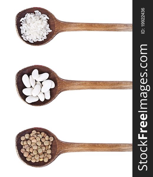 Wood spoons with beans, lentils and rice isolated