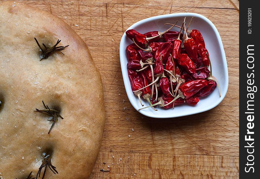 Focaccia bread and chillies on a bread board