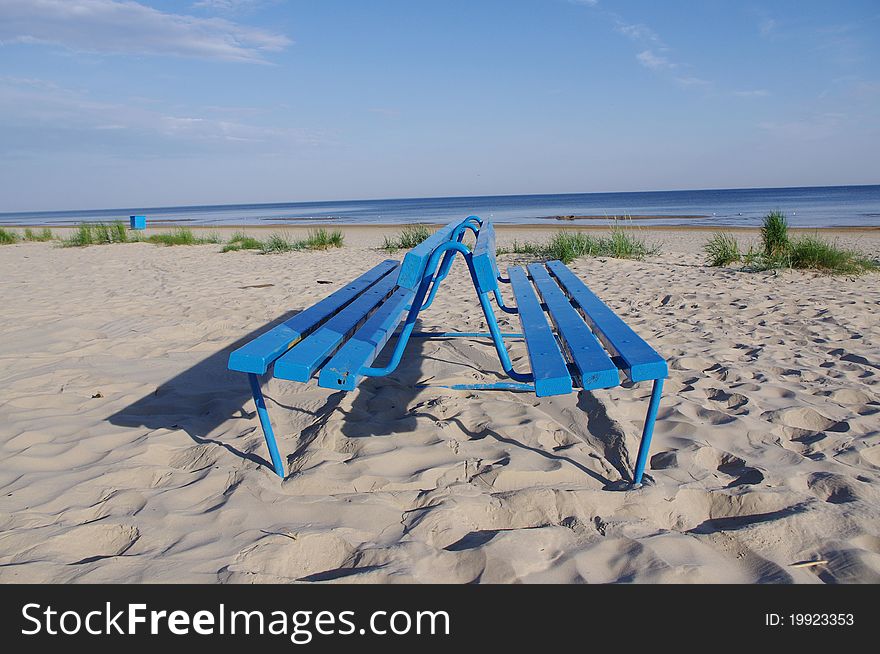 Blue bench on the bank of the Baltic beach. public place