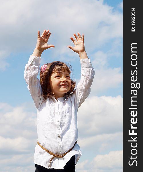 Young girl spreading hands  aginst blue sky with cirrus clouds. Young girl spreading hands  aginst blue sky with cirrus clouds