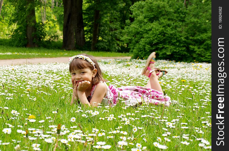 Pretty young girl lying on the grass