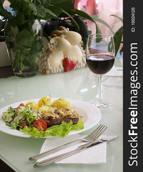 Meat with vegetable garnish and wine. Meat with vegetable garnish and wine
