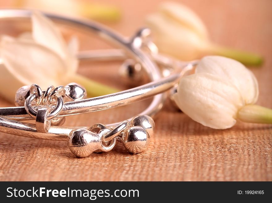 Child leg bracelet closeup with jasmine flowers