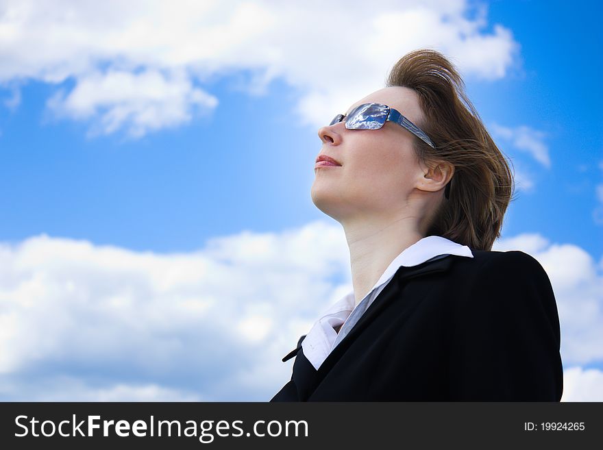Business woman against the sky.
