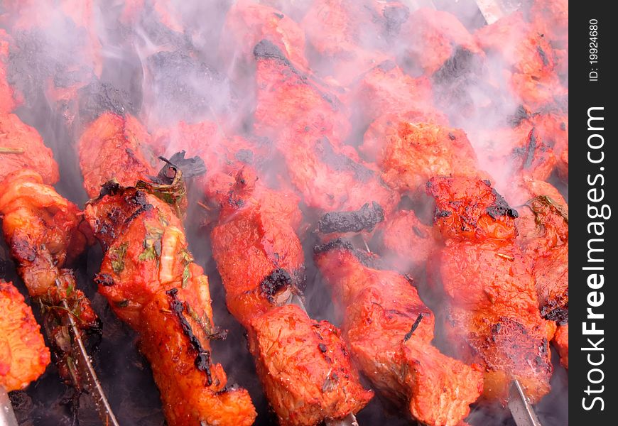 Meat marinaded in sauce is fried on coals. Meat marinaded in sauce is fried on coals