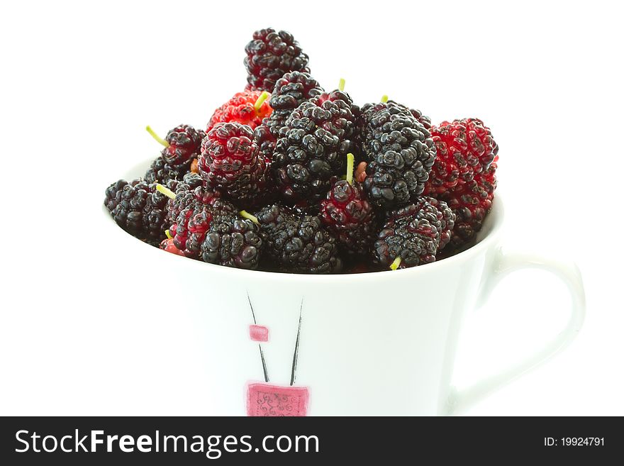 Ripe black mulberries on a white background. Ripe black mulberries on a white background