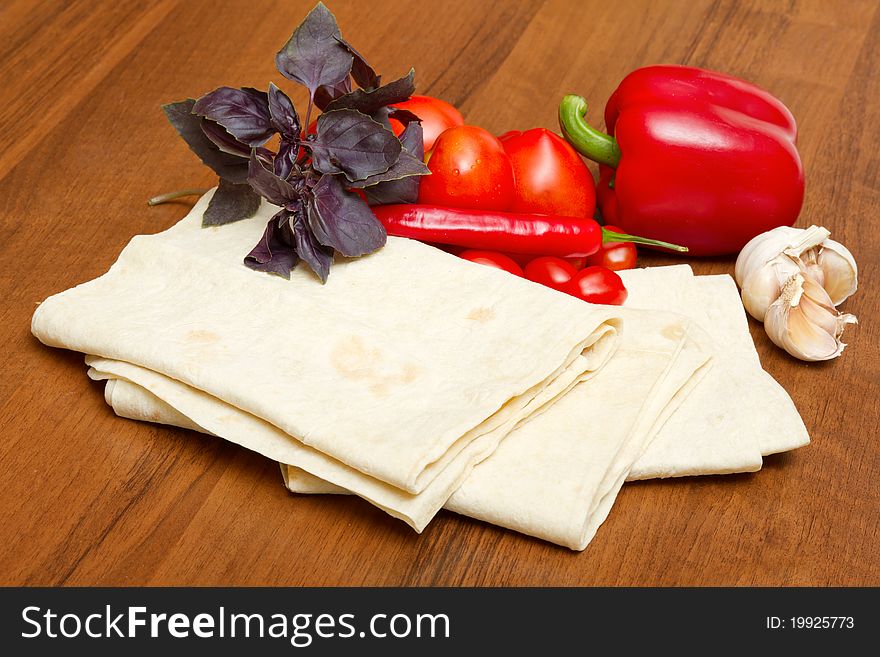 Pita bread and fresh vegetables on the table