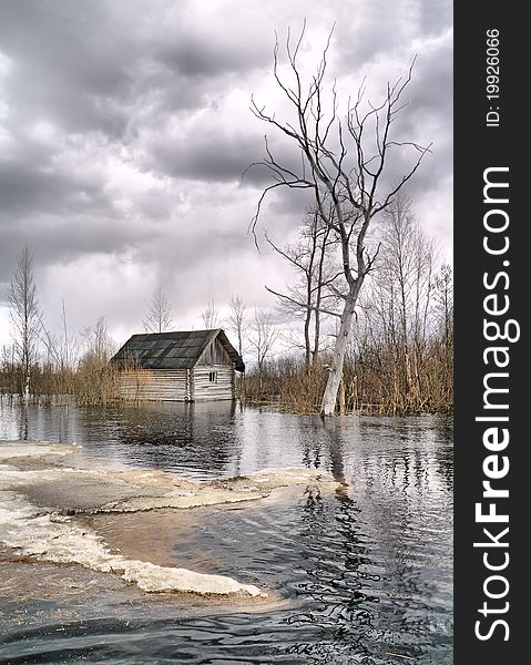 Old wooden house in water