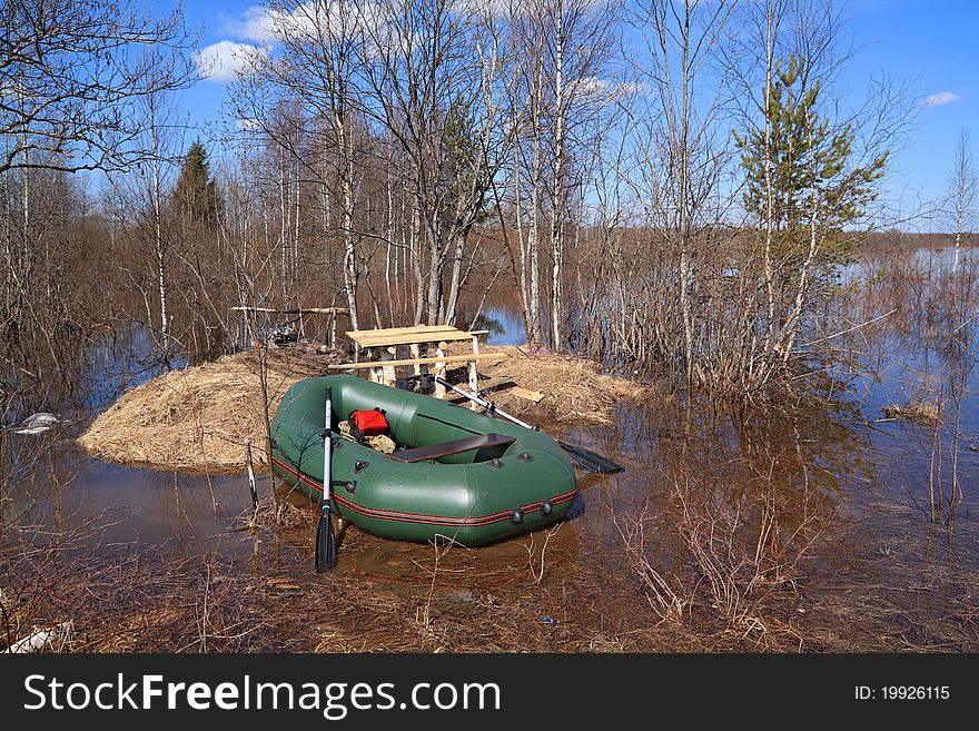 Green rubber boat near coast