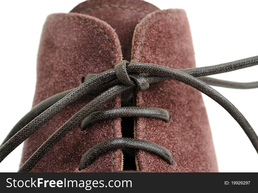 Lace knot in a suede shoe