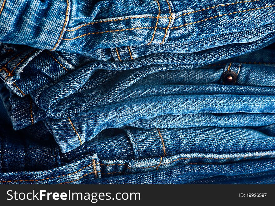 Big stack of blue jeans as a background. Big stack of blue jeans as a background